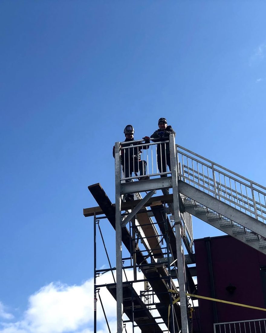 The Dagre Welding Inc. crew atop a galvanized steel staircase tower they fabricated and installed