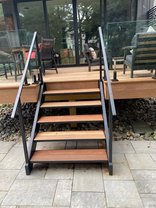 Custom steel-framed deck stairs with hardwood treads and glass railing