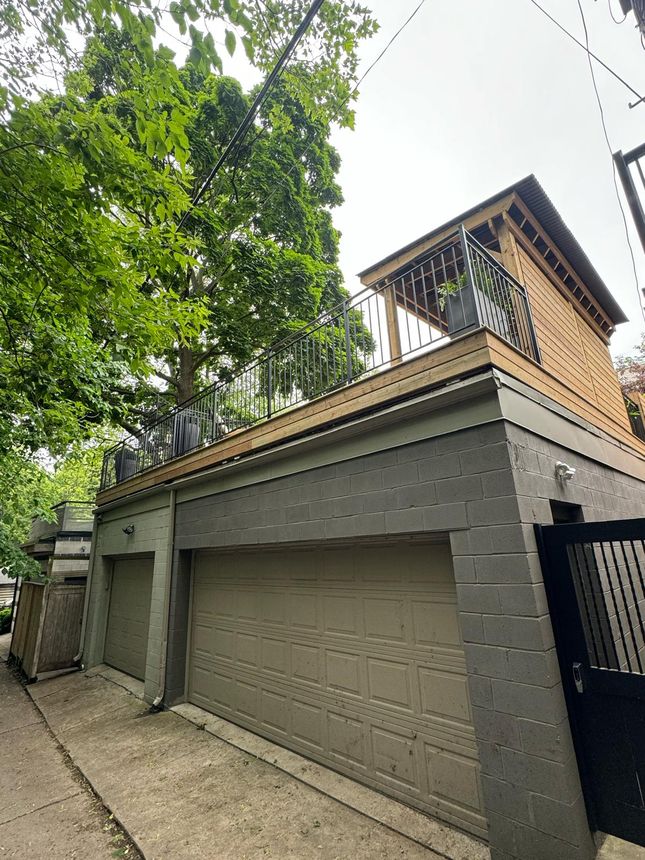 Custom wrought-iron railing enclosing an elevated rooftop deck