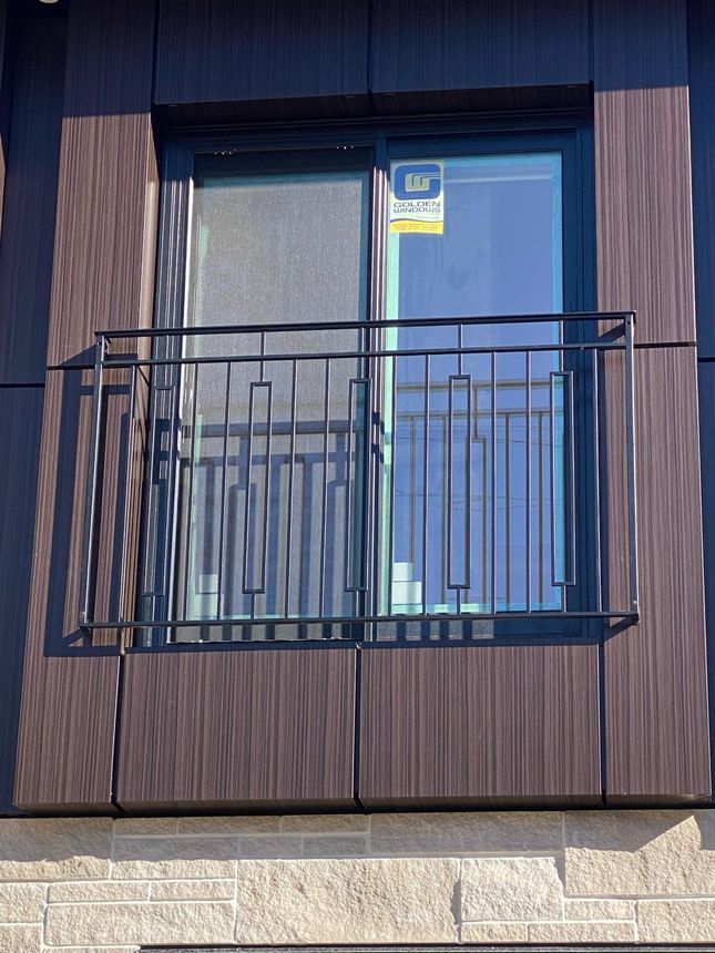 Exterior Juliet balcony railing with a custom decorative panel in black finish