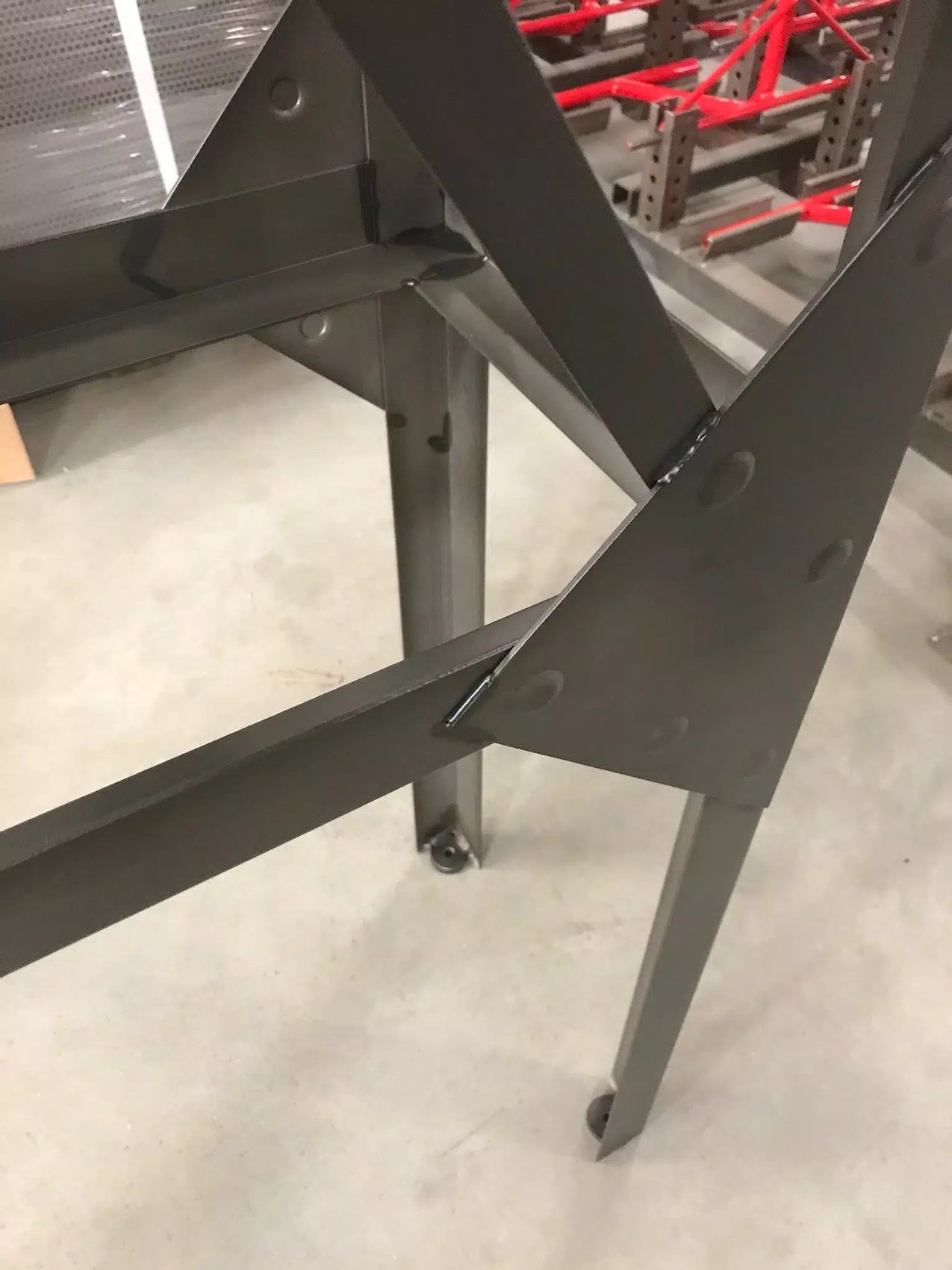 Heavy structural steel framework with precision-welded gusset plates